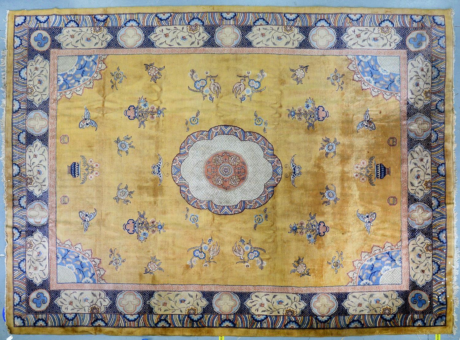 A CHINESE MUSTARD GROUND CARPET, 330 X 444CM, SECOND QUARTER 20TH C Somewhat soiled, for many