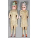 A PAIR OF WAX OVER PAPIER MACHE SHOULDER HEADED CHARACTER DOLLS, IN INTEGRAL PLUMED HAT WITH GLASS