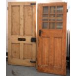 SIX VICTORIAN AND EARLY 20TH C PANELLED PINE DOORS, INCLUDING A FRONT DOOR WITH A BRASS LETTER SLOT,