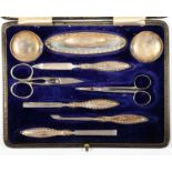 A GEORGE V SILVER MANICURE SET, BY WALKER AND HALL, BIRMINGHAM AND SHEFFIELD 1911, CASED AND A