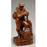 A SWISS BLACK FOREST CARVED AND BROWN STAINED LIMEWOOD FIGURE OF AN ALPINE GUIDE, 45CM H, SIGNED