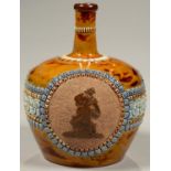 A DOULTON WARE WHISKY JUG, SPRIGGED IN BROWN WITH THE FIGURE OF A WOMAN FEEDING A PIG ON STRAPWORK