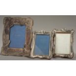 TWO GEORGE V SILVER PHOTOGRAPH FRAMES, THE DIE STAMPED MOUNT BACKED ON WOOD, 18CM H, BOTH BY