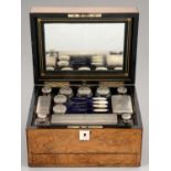 A VICTORIAN SILVER FITTED WALNUT DRESSING CASE  the cut glass accessories with silver cap or cover,
