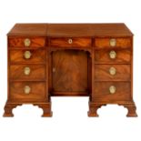 A GEORGE III MAHOGANY KNEEHOLE DRESSING TABLE  the top with two hinged flaps, one revealing an