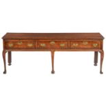 A GEORGE III OAK DRESSER, LATE 18TH C the boarded top with cleated ends, fitted three moulded,