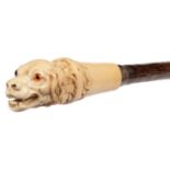 A VICTORIAN BONE CANE HANDLE IN THE FORM OF A HOUND'S HEAD  with glass bead eyes, silver ferrule,