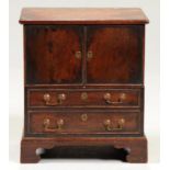 MINIATURE FURNITURE.  A MAHOGANY COMMODE  of chest form with lifting, hinged front and two blind