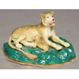 A STAFFORDSHIRE PORCELAIN GROUP OF A LIONESS AND CUB, C1830-45 on rocky green mound, 6cm