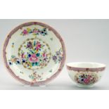 A WORCESTER POLYCHROME TEA BOWL AND SAUCER, C1775-80  enamelled with a floral pattern in compagnie