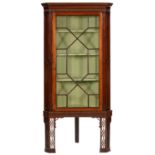 A GEORGE III MAHOGANY CORNER CABINET, LATE 18TH C  with dentil cornice and stop fluted uprights