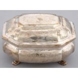 A RUSSIAN SILVER BOMBE SUGAR BOX AND COVER  flat chased with scroll work, on four hairy paw feet,