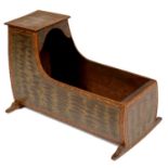 MINIATURE FURNITURE. A PAINTED AND GRAINED BOARDED DEAL CRADLE with black ground trailing floral