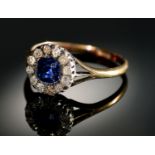 A SAPPHIRE AND DIAMOND RING  the cushion shaped sapphire surrounded by old cut diamonds, gold hoop