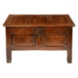 A CHARLES II OAK CHEST, LATE 17TH C  the three panel lid with iron loop hinges, the front with