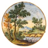 A CASTELLI MAIOLICA PLATE, MID 18TH C  painted with two travellers by a river in an extensive