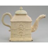 A STAFFORDSHIRE HOUSE SHAPED SLIP CAST WHITE SALTGLAZED STONEWARE TEAPOT  C1745  13cm h and a