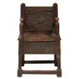 A JOINED OAK PANEL BACK CHILD'S ARMCHAIR  67cm h An old reconstruction incorporating 17th.18th c