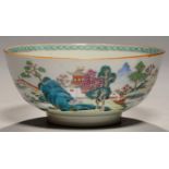 A CHINESE FAMILLE ROSE BOWL, C1770  enamelled with a landscape with temple and hut and two