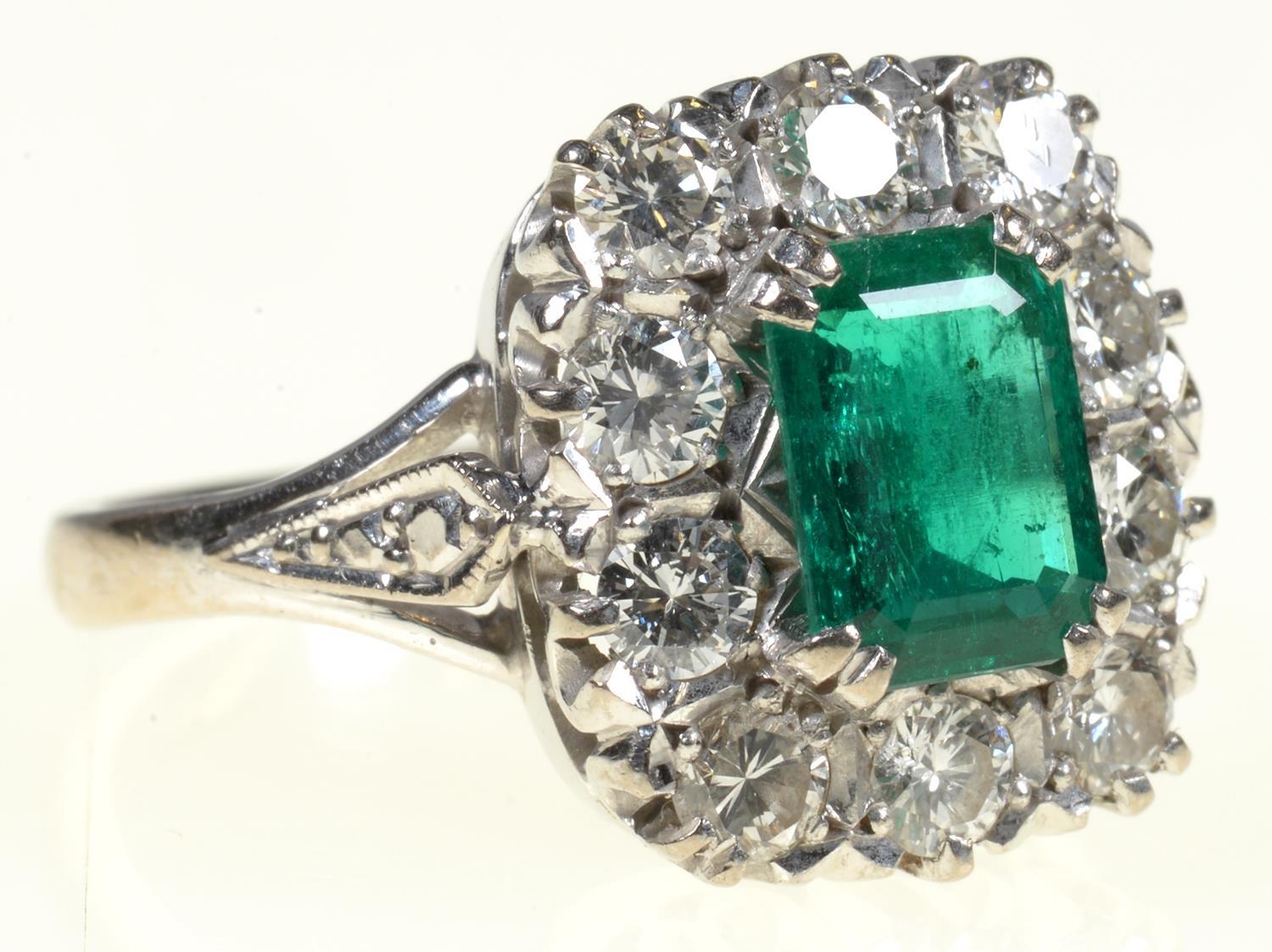 AN EMERALD AND DIAMOND RING  the step cut emerald of approx 4 x 6mm in a surround of ten evenly - Image 7 of 7