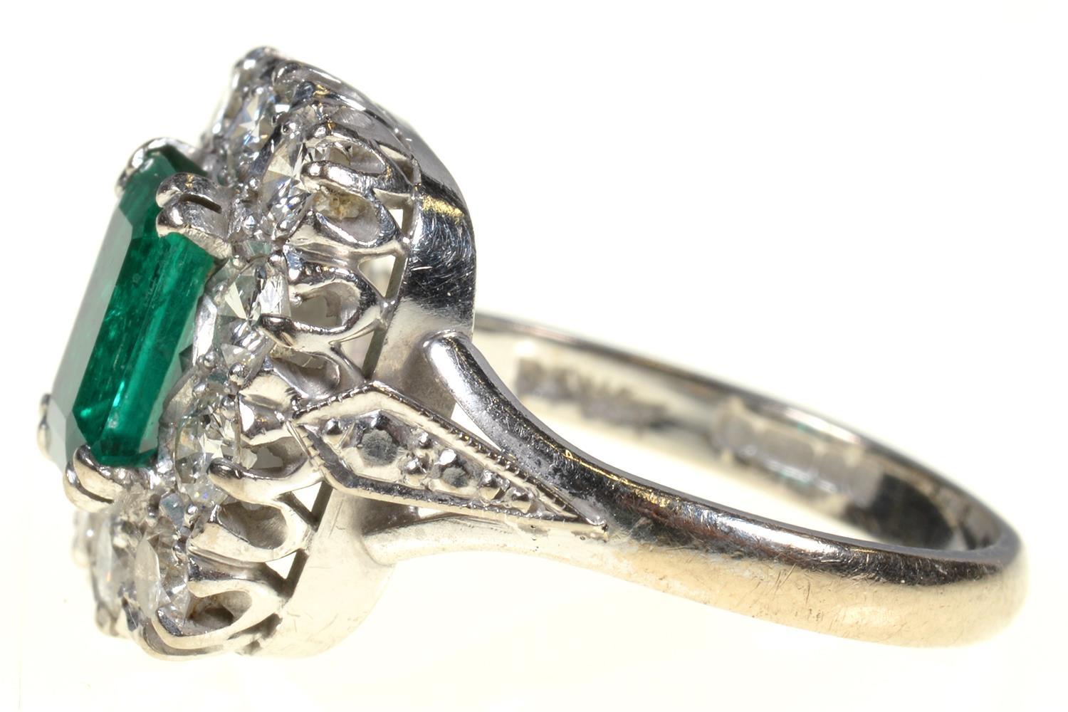 AN EMERALD AND DIAMOND RING  the step cut emerald of approx 4 x 6mm in a surround of ten evenly - Image 5 of 7