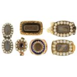 A GROUP OF GOLD MOURNING BROOCHES AND SLIDES  all but one set with split pearls, two enamelled,