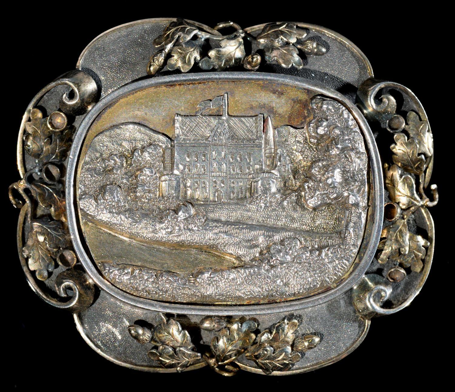 ROYAL.  A PARCEL GILT SILVER BROOCH with cast oblong engraved bas relief view of a schloss, possibly