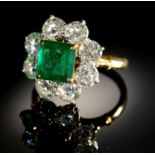 AN EMERALD AND DIAMOND RING,  with step cut emerald of approx 6 x 6mm and of approx 2ct, in a