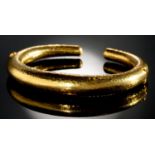 ILIAS LALAOUNIS. A GREEK GOLD BANGLE with two invisible hinges, 74mm, maker's and control mark,