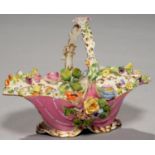 A COALPORT FLORAL ENCRUSTED BLANCMANGE PINK GROUND SHELL BASKET  the interior painted with sprays