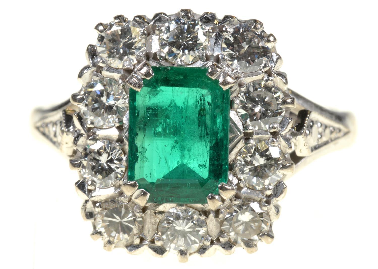 AN EMERALD AND DIAMOND RING  the step cut emerald of approx 4 x 6mm in a surround of ten evenly - Image 2 of 7