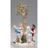 A MEISSEN GROUP OF FOUR CHILDREN DANCING AROUND A PEAR TREE, LATE 19TH C after the model by J J