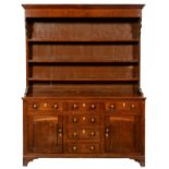 AN OAK DRESSER NORTH WALES,  EARLY 19TH C with moulded cornice to the boarded rack, profile