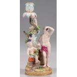 A MEISSEN FIGURAL CANDLESTICK EMBLEMATIC OF AUTUMN FROM THE FOUR SEASONS, LATE 19TH/EARLY 20TH C