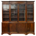 AN EDWARDIAN MAHOGANY BREAKFRONT LIBRARY BOOKCASE, EARLY 20TH C  with stepped cornice and fitted