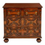 A WILLIAM AND MARY STYLE GEOMETRIC MOULDED OAK CHEST OF DRAWERS, 20TH C  with brass drop handles, on