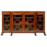 A MAHOGANY BREAKFRONT BOOKCASE, C1900  fitted with adjustable shelves enclosed four doors with