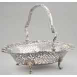 A GEORGE III PIERCED SILVER BASKET with finely cast and applied openwork border of trailing roses