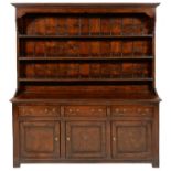 A GEORGE III OAK DRESSER, EARLY 19TH C  with boarded rack, the base fitted with drawers and three