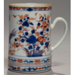 A CHINESE IMARI MUG, 18TH C decorated with two phoenix between flowering plants, 15.5cm h Descending