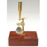 AN ENGLISH BRASS CAREY TYPE MICROSCOPE, C1840   with concave mirror, three bone sliders, stage