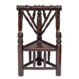 MINIATURE FURNITURE.  A FRUITWOOD TURNER'S CHAIR  with triangular seat and bone pins, 23cm h