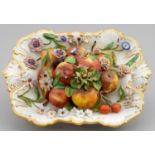 A STAFFORDSHIRE PORCELAIN TROMPE L'OEIL DISH OF FRUIT AND FLOWERS, C1830 28cm l Typical slight