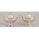 A PAIR OF GEORGE IV OVAL SILVER SAUCE TUREENS AND COVERS with reeded ring handles and crested,