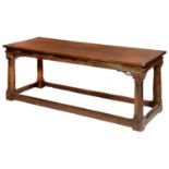 A JAMES I STYLE OAK REFECTORY TABLE  the single plank top on four architectural columnar legs united