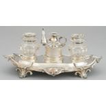 A VICTORIAN SILVER INKSTAND  of leafy scrolling oblong design, with silver taperstick and silver