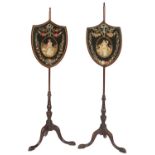 TWO MAHOGANY POLE SCREENS, 19TH C  each with shield shaped needlework applique and painted banner