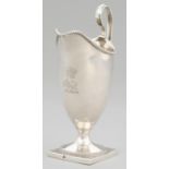 A GEORGE III HELMET SHAPED SILVER CREAM JUG with beaded rims, crested, 16.5cm h, by Robert