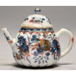A CHINESE IMARI LOBED TEAPOT AND A COVER, EARLY 18TH C  painted with flowers, 10.5cm h Chip under