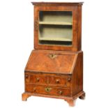 MINIATURE FURNITURE.  A WALNUT BUREAU CABINET  with barber pole stringing, glazed door, fitted